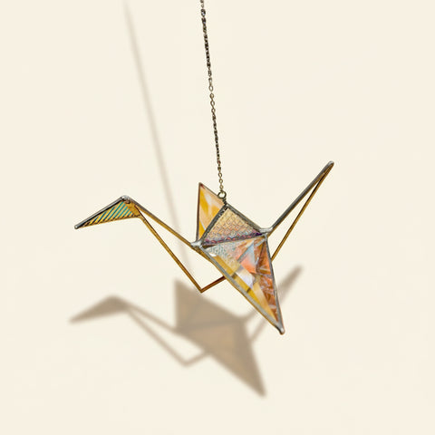 Star-shaped glass ornament on a wooden table with a blurred background