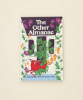 Book titled 'The Other Almanac' on a wooden surface