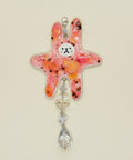Decorative starfish with crystal elements on a wooden surface
