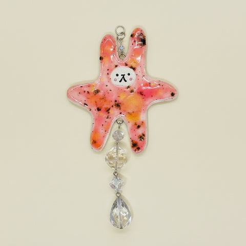 Decorative starfish with crystal elements on a wooden surface