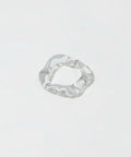 Clear glass ring with wavy design on a white background