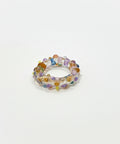 Multicolored beaded ring on a wooden surface