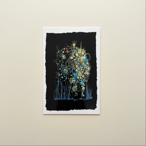 Artistic depiction of a creature with floral elements on a wooden surface