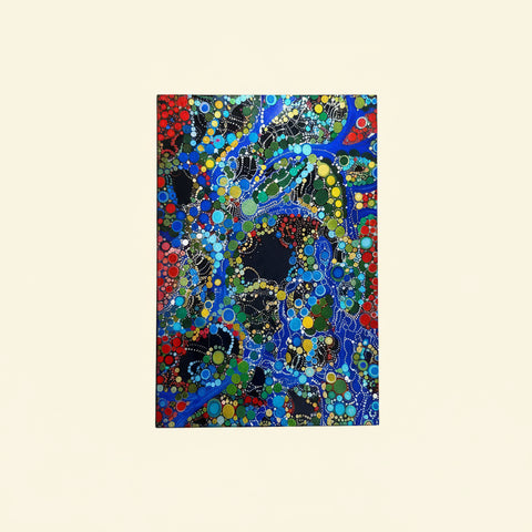 Colorful abstract dot art on a wooden surface with a marker.