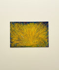 Abstract painting with yellow and blue on a wooden surface