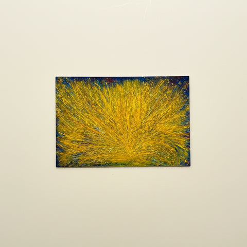 Abstract painting with yellow and blue on a wooden surface