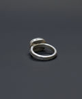 Silver ring on a wooden surface
