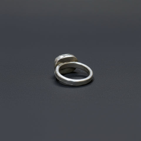 Silver ring on a wooden surface