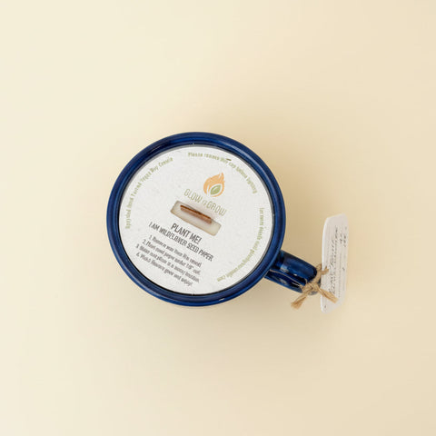 Blue mug with a plantable seed paper label on a wooden surface