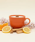 Orange mug with a tea bag on a wooden surface