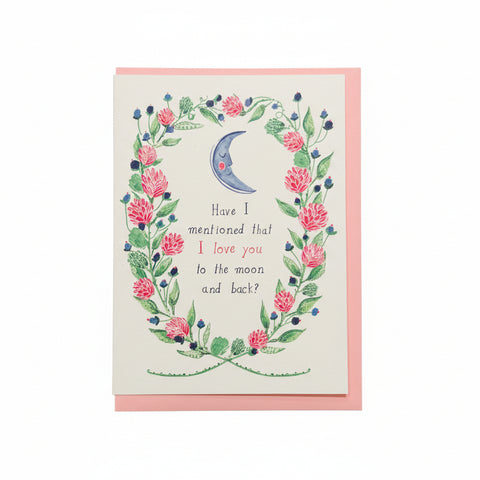 Greeting card with floral design and text on a wooden surface