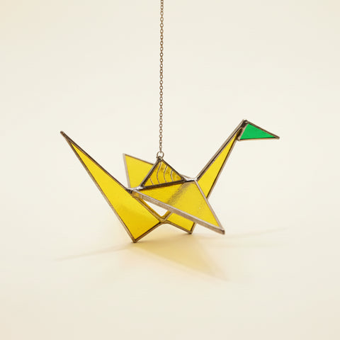stained glass sun catcher shaped like a paper crane.
