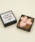 Heart-shaped steamers in a box with a sign indicating 'Lavender' on a wooden surface.
