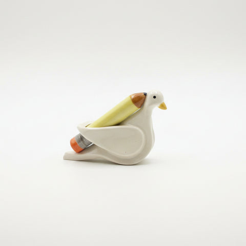 Decorative bird-shaped sculpture holding a sculpted pencil