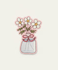 Sticker of flowers in a jar on a wooden surface
