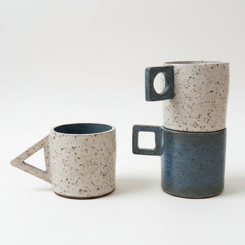 Speakers on a wooden surface with a blurred background