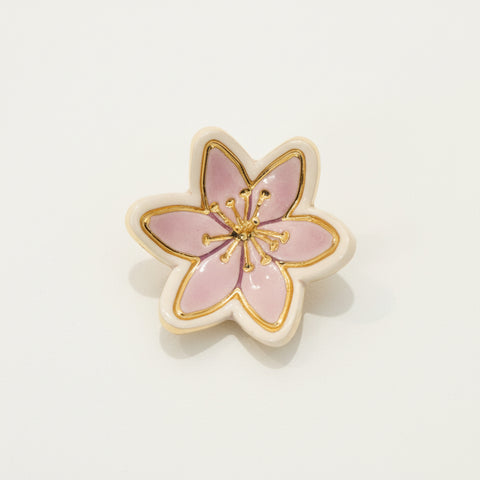 Floral ring dish on a wooden surface