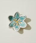 Decorative ceramic flower on a wooden surface