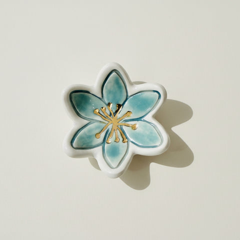 Decorative ceramic flower on a wooden surface