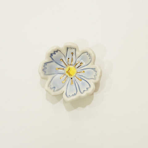 Floral ceramic ring dish on a wooden surface