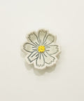 Flower-shaped object on a wooden surface