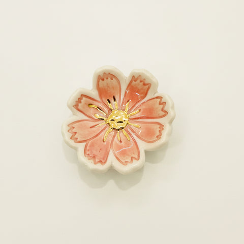 Floral ceramic ring dish on a wooden surface