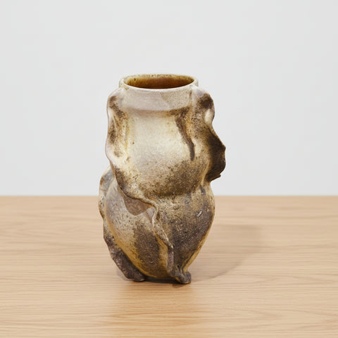 Ceramic vase shaped like a bear on a desk with office supplies in the background