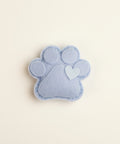 Catnip toy packaging with paw design on a textured surface