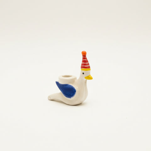 Decorative ceramic bird figurine with a colorful party hat