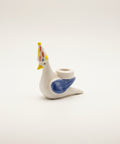 Small ceramic figurine of a bird with a party hat