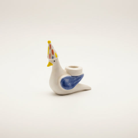 Small ceramic figurine of a bird with a party hat