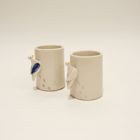 Two ceramic espresso cups with pigeon shaped handles