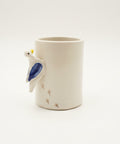 White ceramic mug with a bird shaped handle