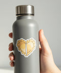 Heart-shaped pierogi sticker on a grey water bottle.