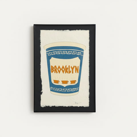 Framed artwork of a blue and white cup with 'Brooklyn' text.