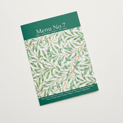 Menu No 7 with green leaf pattern on a wooden surface