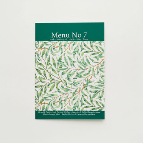 Menu No 7 with green leaf pattern on a wooden surface