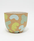 Ceramic planter pot with an abstract pattern.