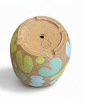 The bottom of a ceramic planter pot with a drainage hole.