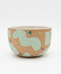 Ceramic bowl with a randomized surface pattern.