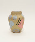 Decorative vase with abstract patterns on a wooden surface
