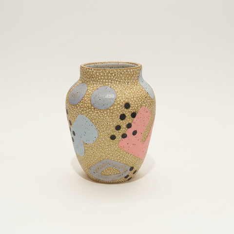 Decorative vase with abstract patterns on a wooden surface