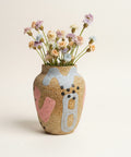 Decorative vase with artistic design on a wooden surface