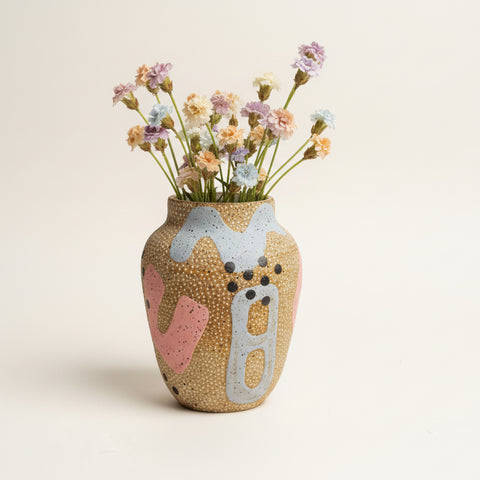 Decorative vase with artistic design on a wooden surface