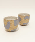 Two ceramic cups with a textured design.