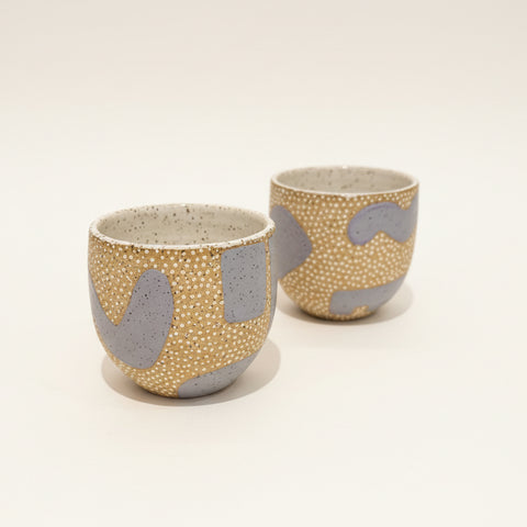 Two ceramic cups with a textured design.