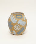 Ceramic vase with abstract patterns on a wooden table