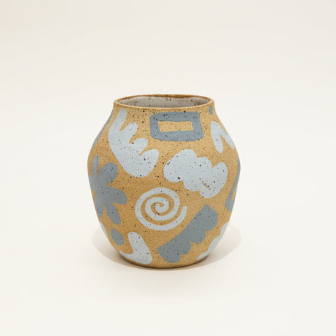 Ceramic vase with abstract patterns on a wooden table