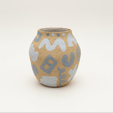 Ceramic vase with abstract patterns on a wooden surface