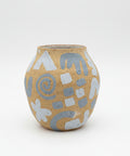Ceramic vase with abstract patterns on a wooden surface